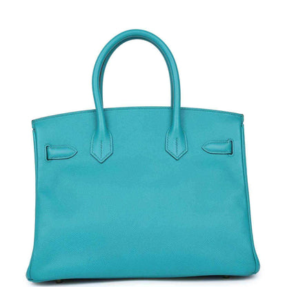 Blue peacock leather tote bag with top handles and front flap detail