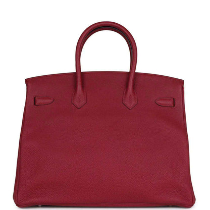 Red leather Birkin-style handbag front panel with embossed pockets and top handles
