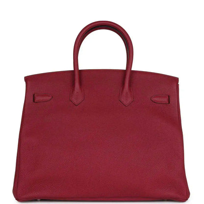 Red leather Birkin-style handbag front panel with embossed pockets and top handles