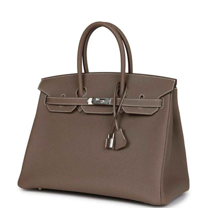 Hermes Birkin 35 taupe Togo leather handbag with top handles, front clasp and hanging key charm