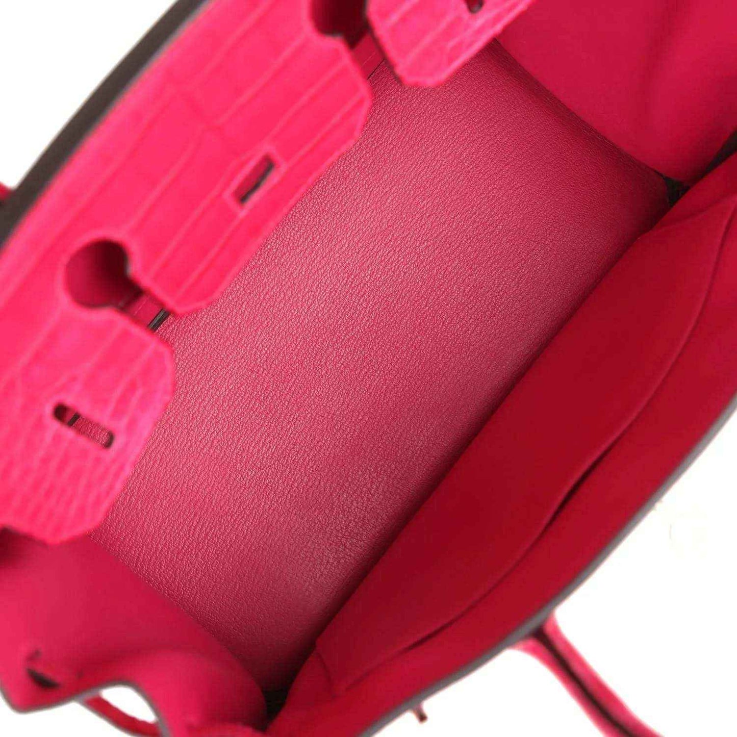Pink Birkin handbag interior pocket and strap details with hardware accents.