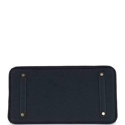Leather handbag base panel with gold corner studs and stitched edges, dark color