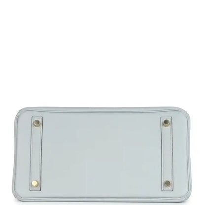 Pale blue leather handbag back panel with two metal corner tabs and stitching