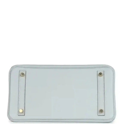 Pale blue leather handbag back panel with two metal corner tabs and stitching