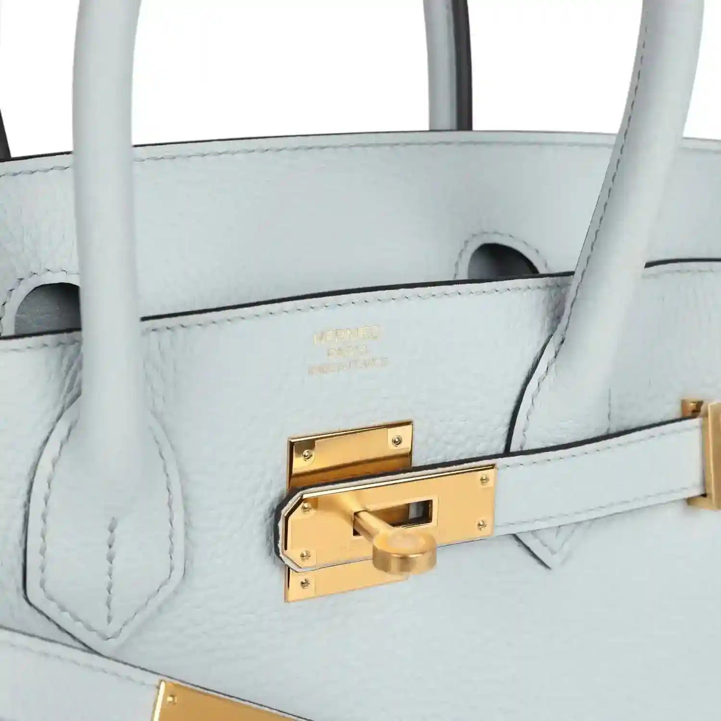 Pale blue leather handbag close-up of gold front clasp and stitched panel detail