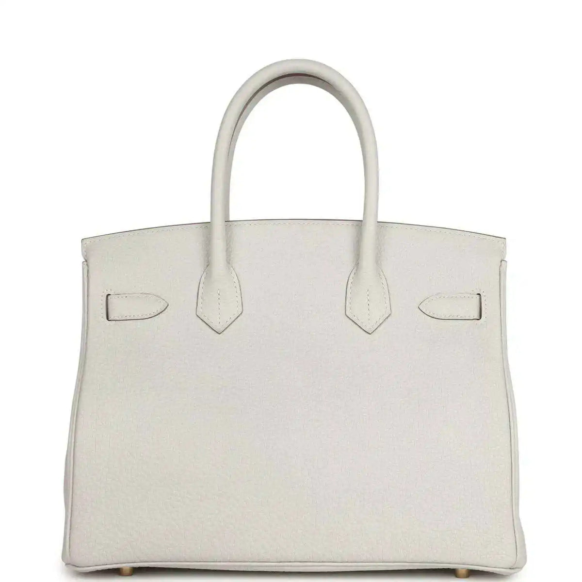 Light gray leather handbag front view with three panel straps, top handles, gold-toned details
