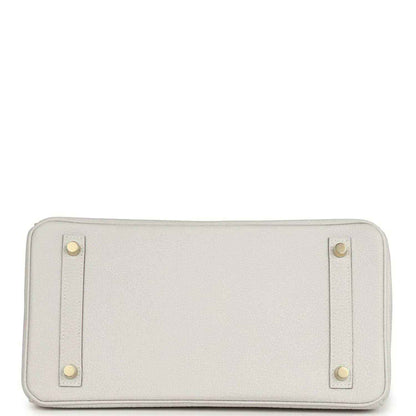 Light gray leather pouch panel with four corner studs and zip opening