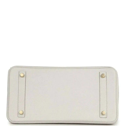 Light gray leather pouch panel with four corner studs and zip opening