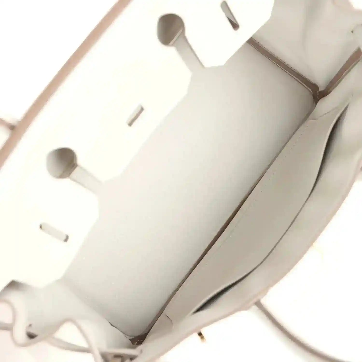 Light gray interior lining with cutout pockets and seam stitching