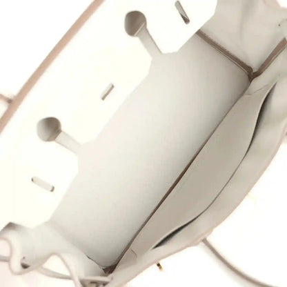 Light gray interior lining with cutout pockets and seam stitching