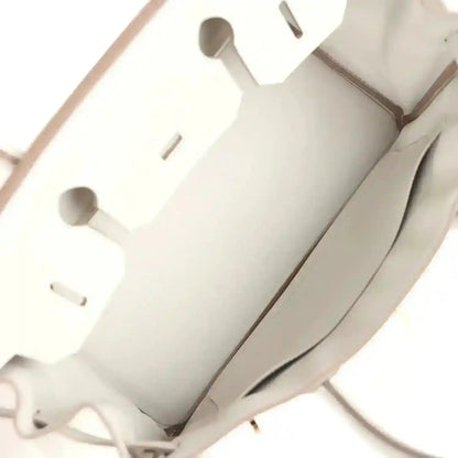 Light gray interior lining with cutout pockets and seam stitching