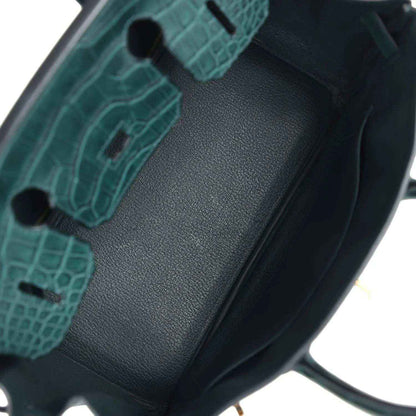 Birkin handbag interior lining detail in dark green with textured insert