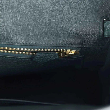 Birkin handbag interior zipper pocket in dark green leather with gold zipper pull