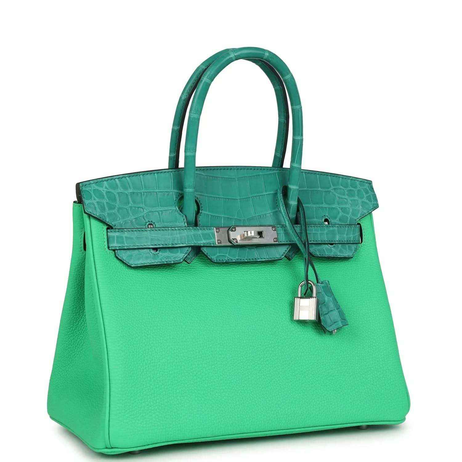 Green leather handbag with crocodile texture, top handles, front flap and dangling lock charm