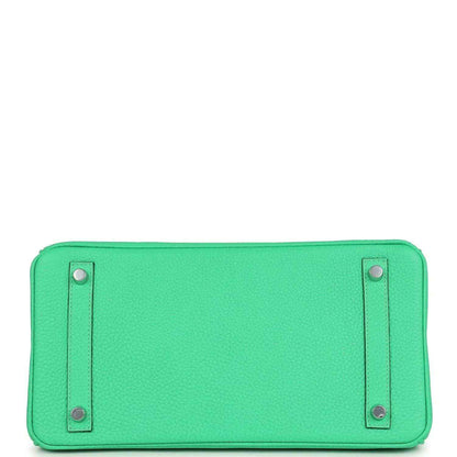 Green leather handbag base with two metal snap studs on a smooth panel