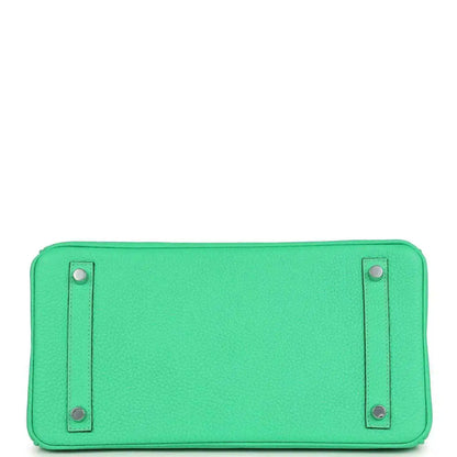 Green leather handbag base with two metal snap studs on a smooth panel