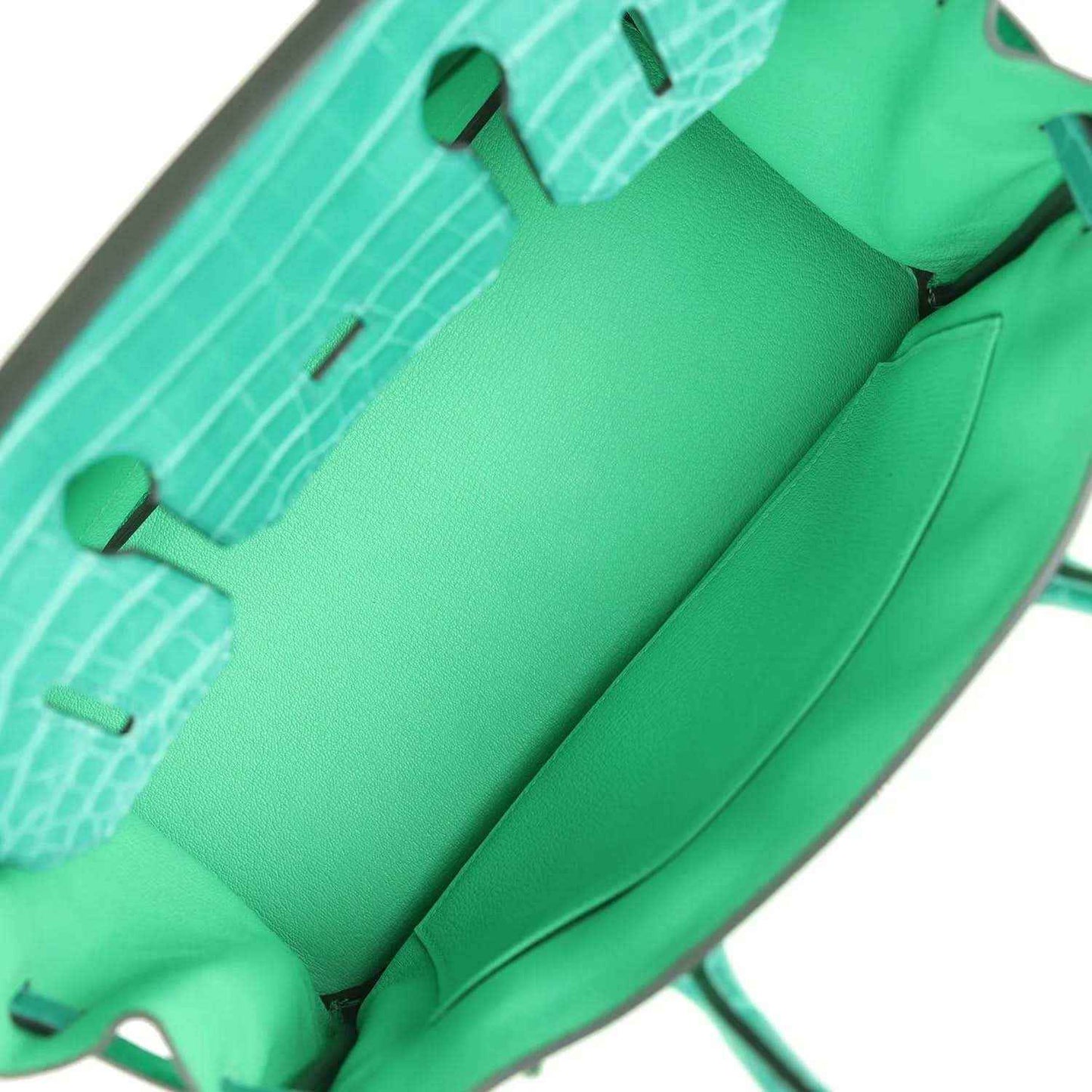 Green leather handbag interior lining with stitched seams and inner pockets