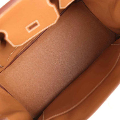 Hermes Birkin 30 handbag interior view with gold-brown leather lining and partitioned pocket