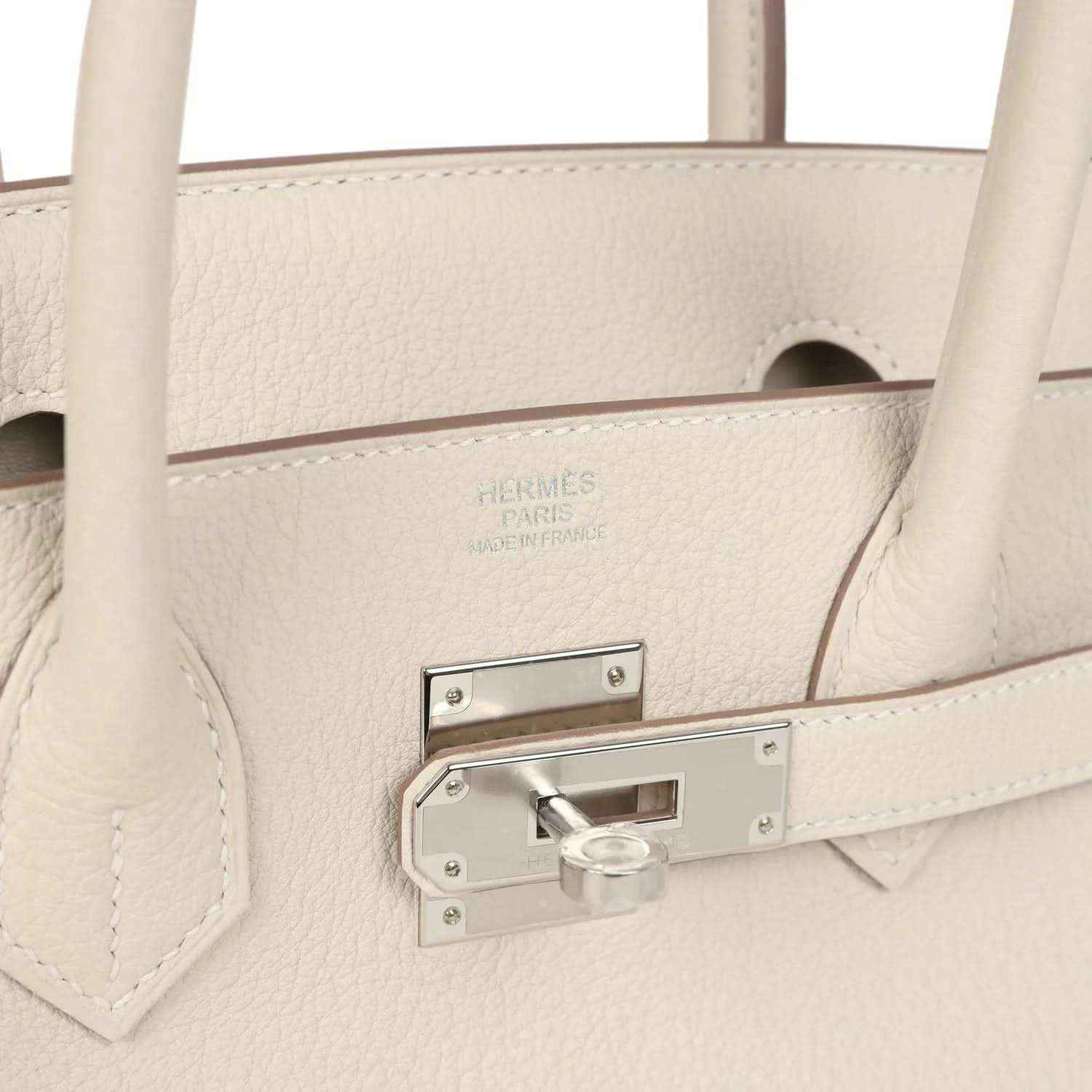 Birkin 30 handbag close-up of light cream leather with stamped logo and padlock bar