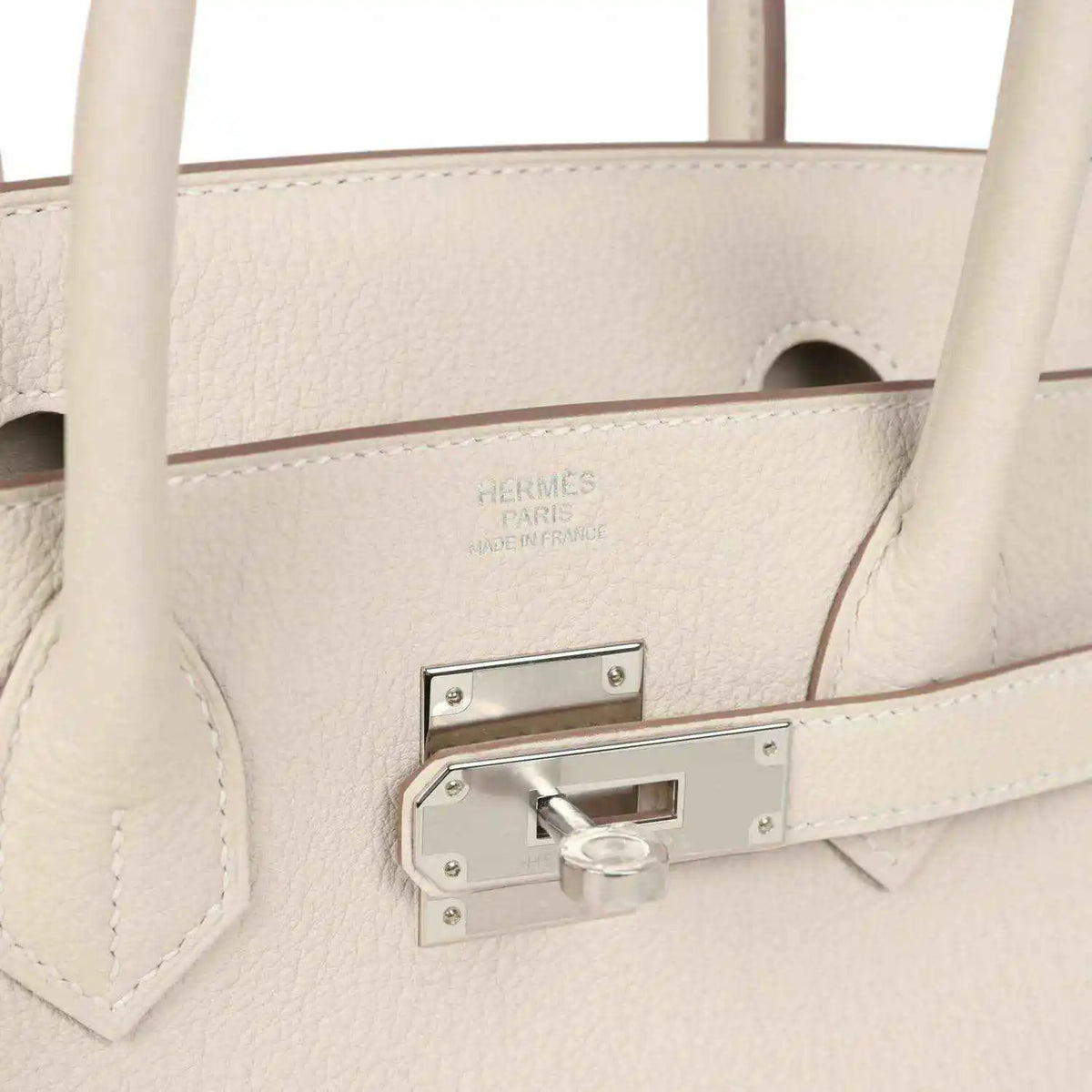 Birkin 30 handbag close-up of light cream leather with stamped logo and padlock bar