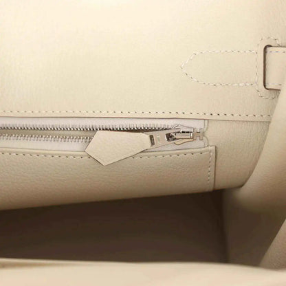 Birkin 30 handbag interior with light cream zip pocket and metal clasp hardware