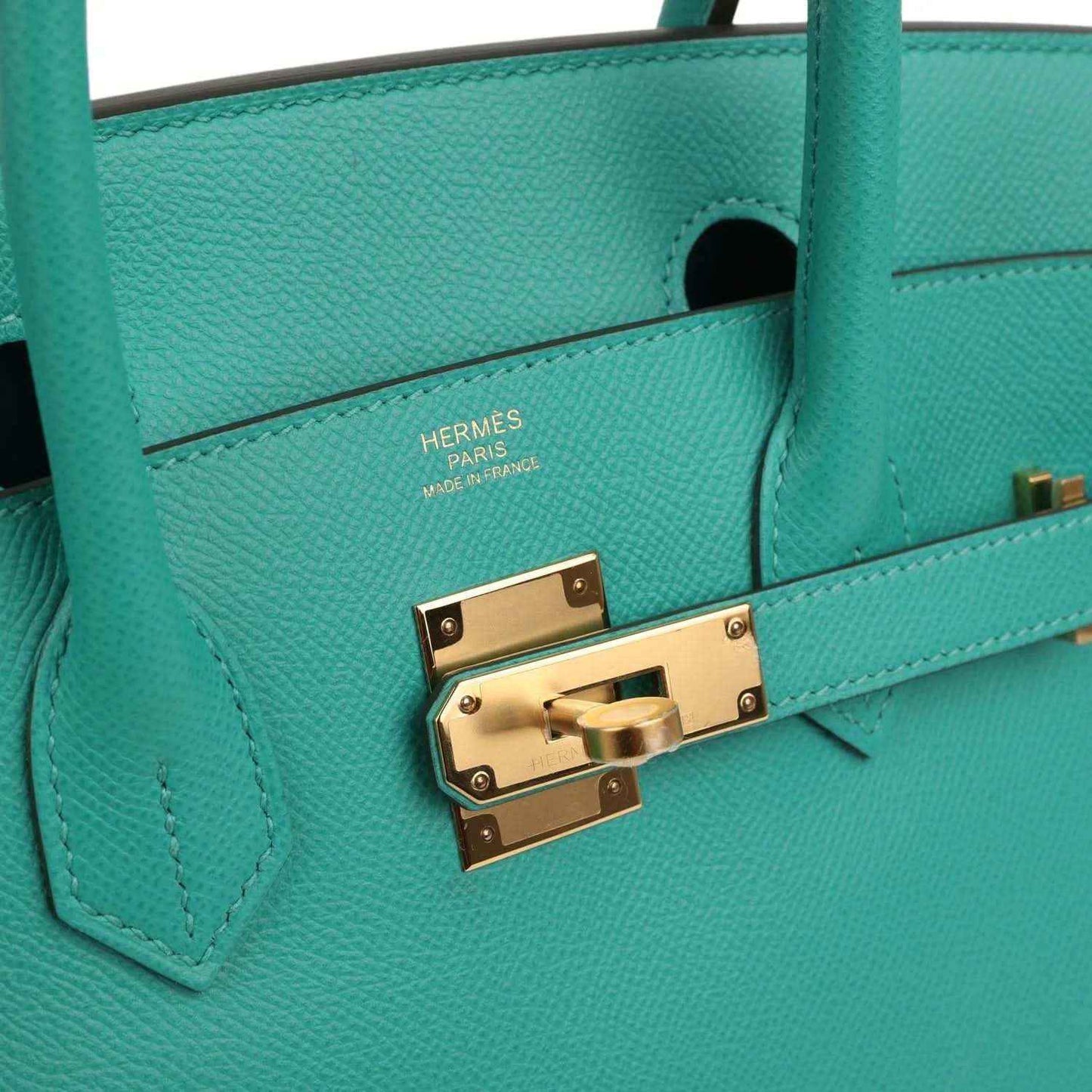 Hermes lock plate on green leather handbag with 'HERMES PARIS' engraving