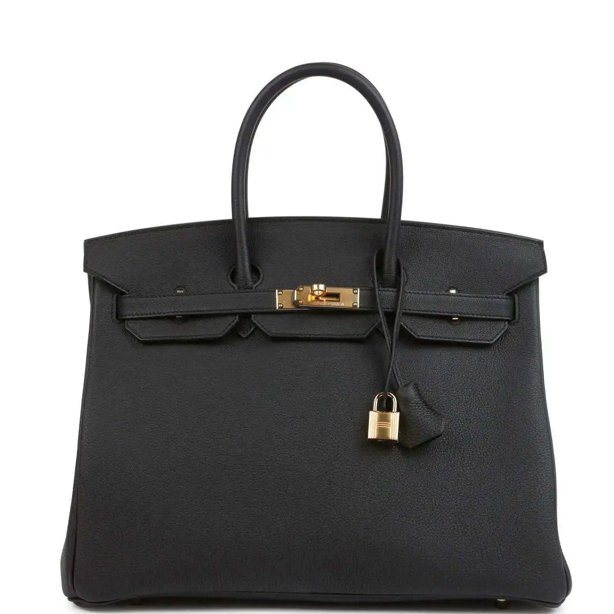 Black leather handbag with gold turn-lock, front flap, and top handles