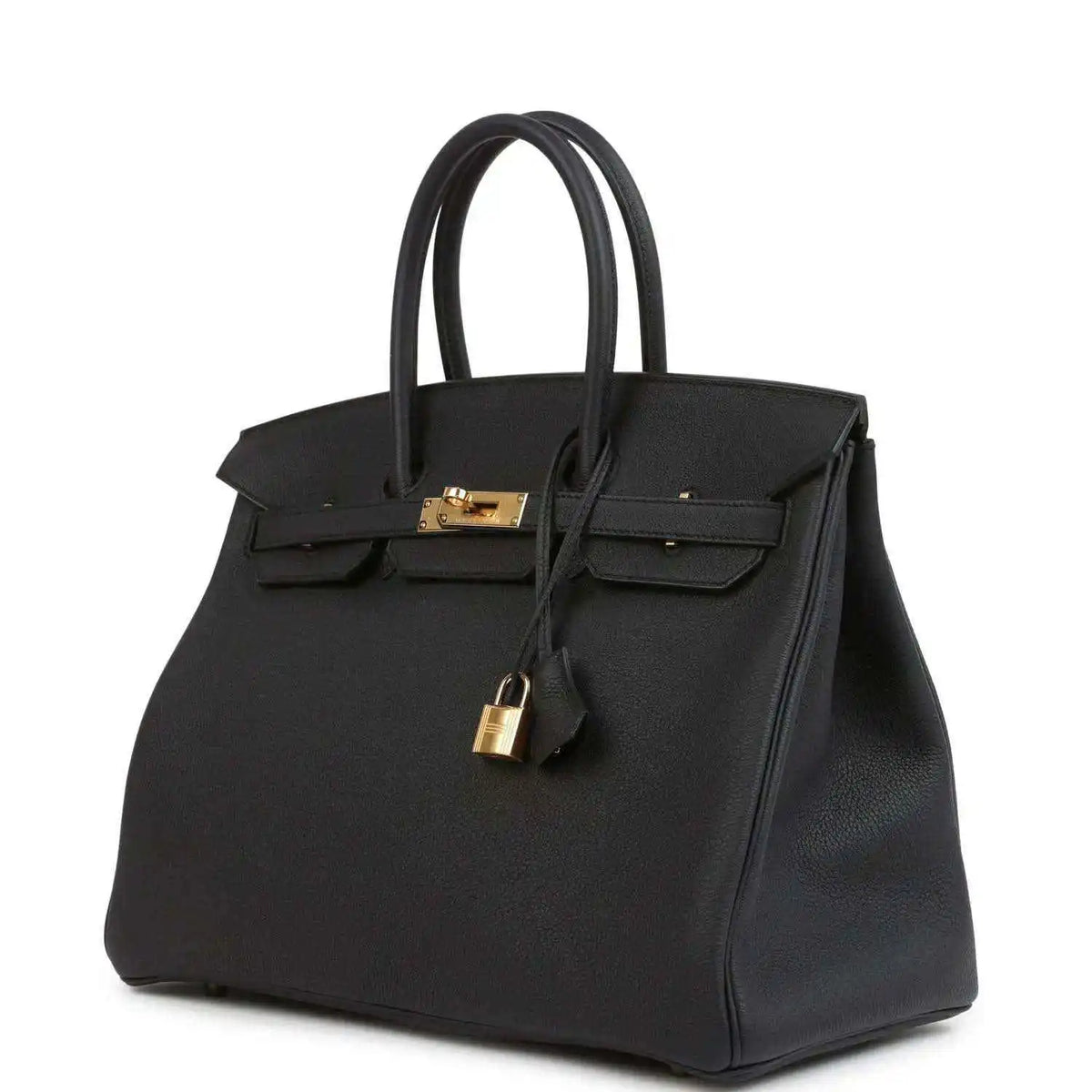 Black leather handbag with gold turn-lock and front flap, angled view