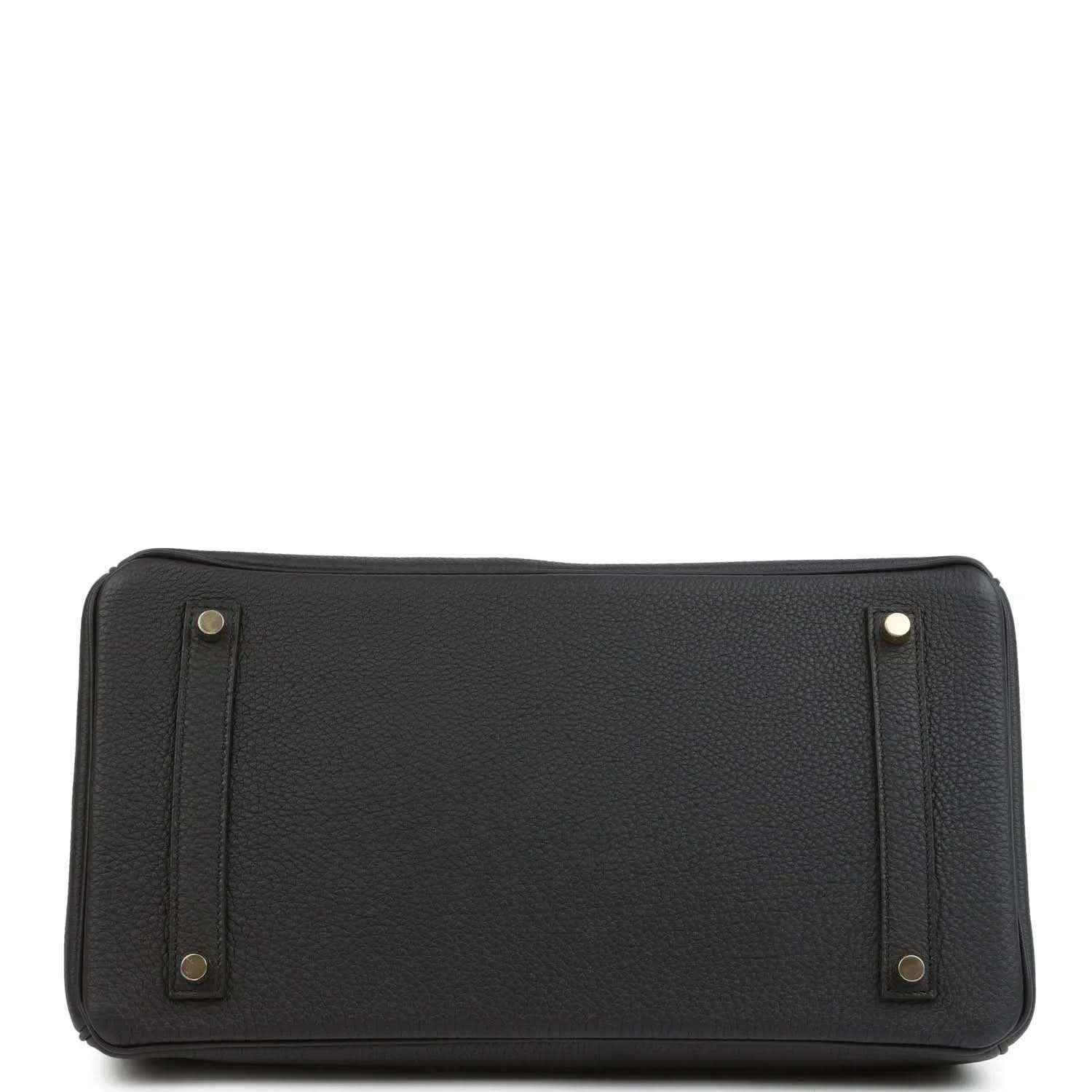 Black leather handbag with reinforced base corners and side handle attachments
