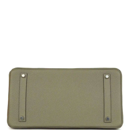 Sauge leather handbag back panel with two strap tabs and metal rivets