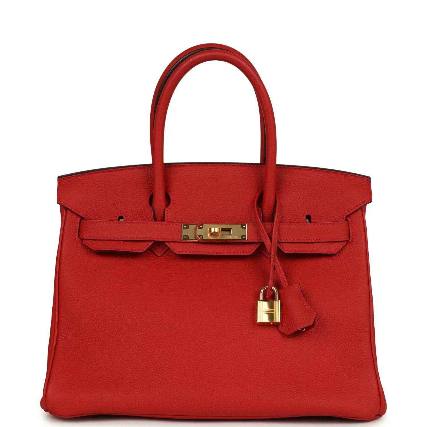 Red leather handbag with gold front clasp, lock, and top handles