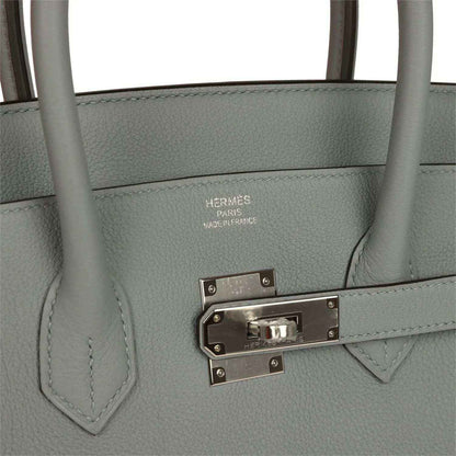 Gray Birkin 35 handbag close-up of silver-tone front clasp and engraved hardware