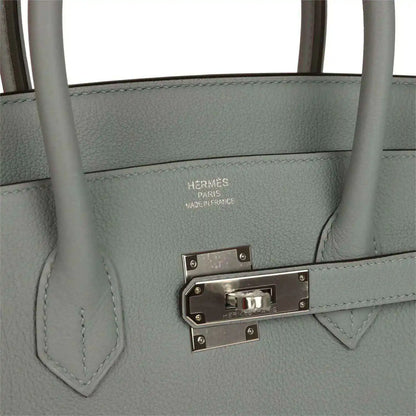 Gray Birkin 35 handbag close-up of silver-tone front clasp and engraved hardware