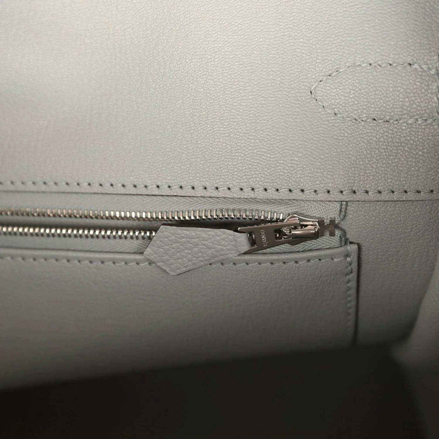 Birkin 35 handbag interior close-up of zipper pull and stitched trim
