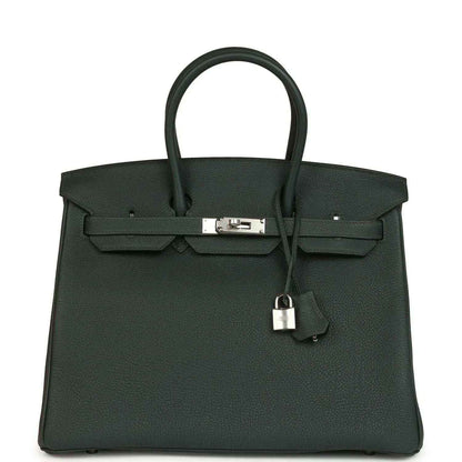 Structured handbag in dark green Togo leather with top handles and silver-tone front lock