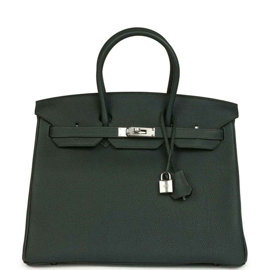 Structured handbag in dark green Togo leather with top handles and silver-tone front lock