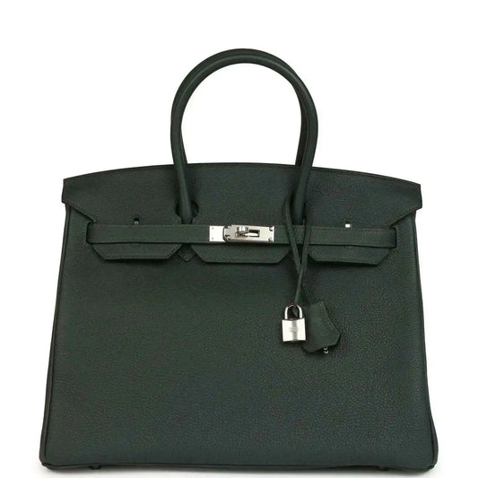 Structured handbag in dark green Togo leather with top handles and silver-tone front lock