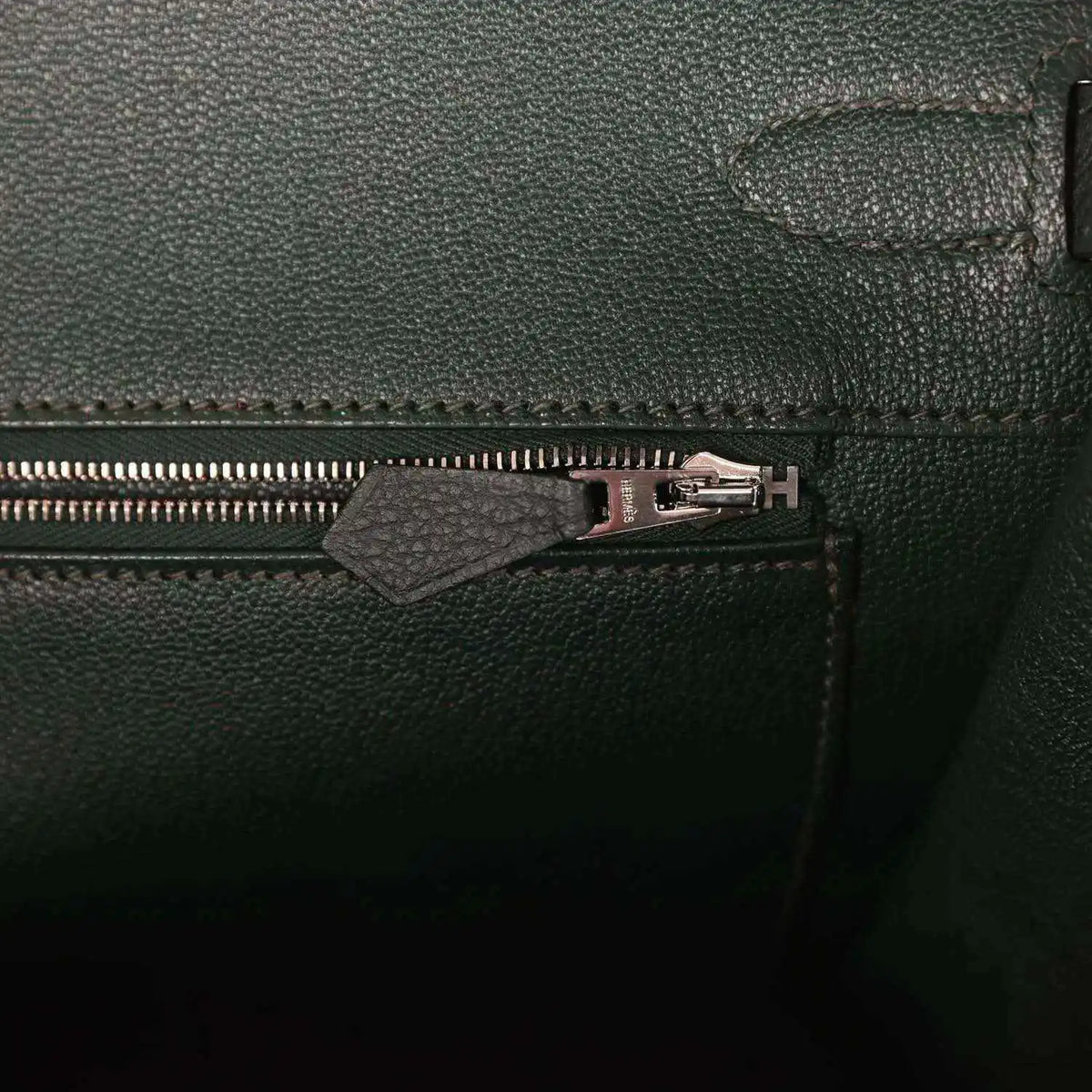 Dark green Togo leather handbag with front zipper and silver-tone pull hardware