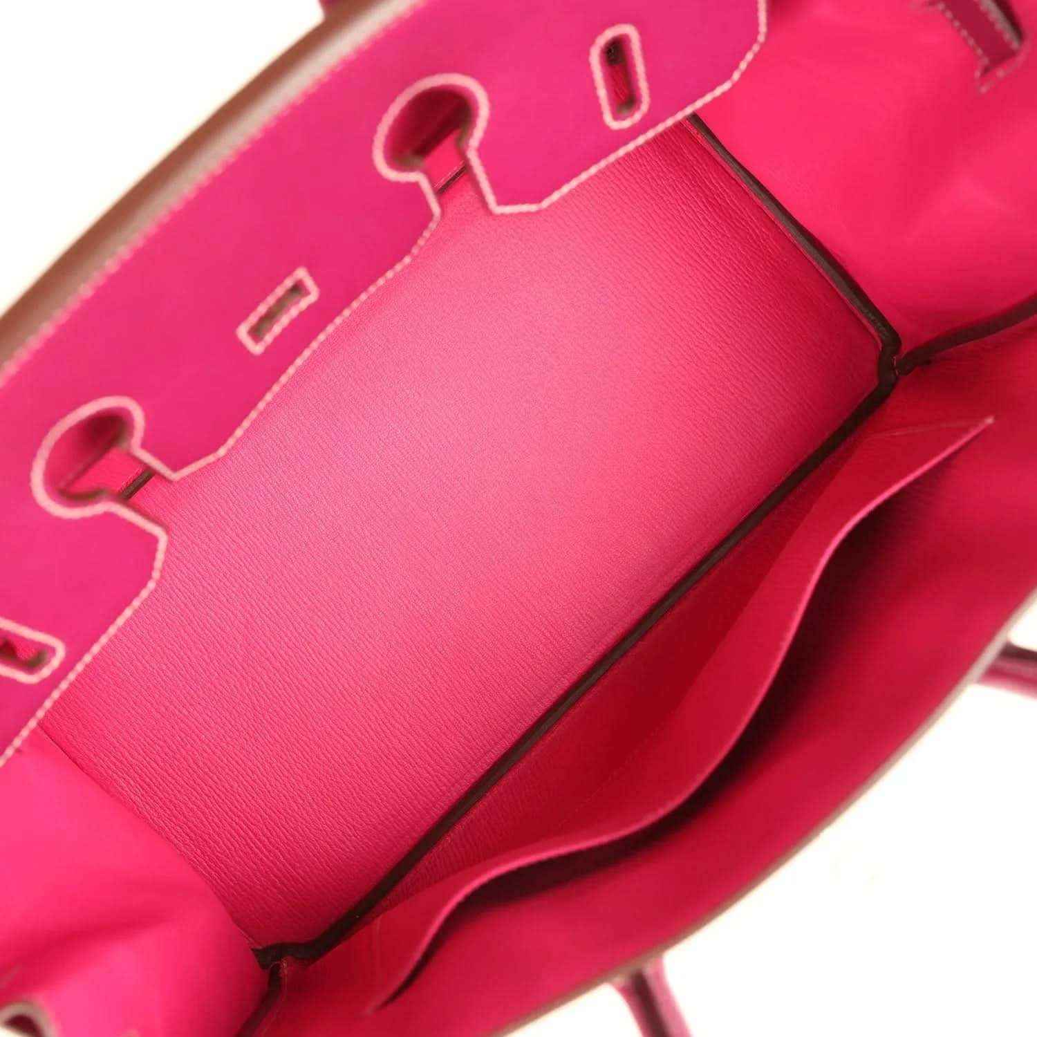 Pink leather interior with contrast stitching and a metal zipper pull detail.