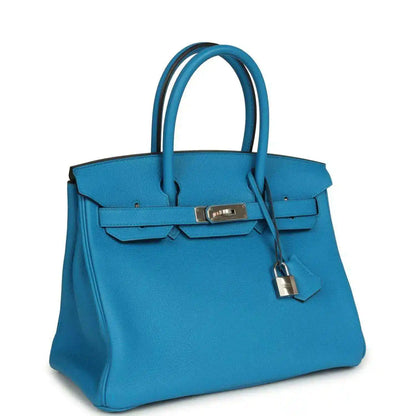 Blue leather Birkin-style handbag with top handles and front flap lock hardware