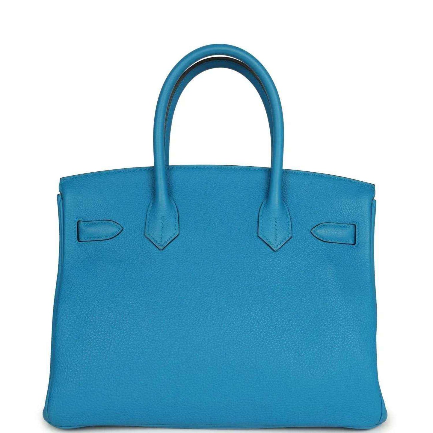 Blue leather handbag with front exterior pockets and top handles