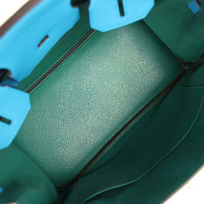Blue leather handbag interior with green leather lining and side compartment