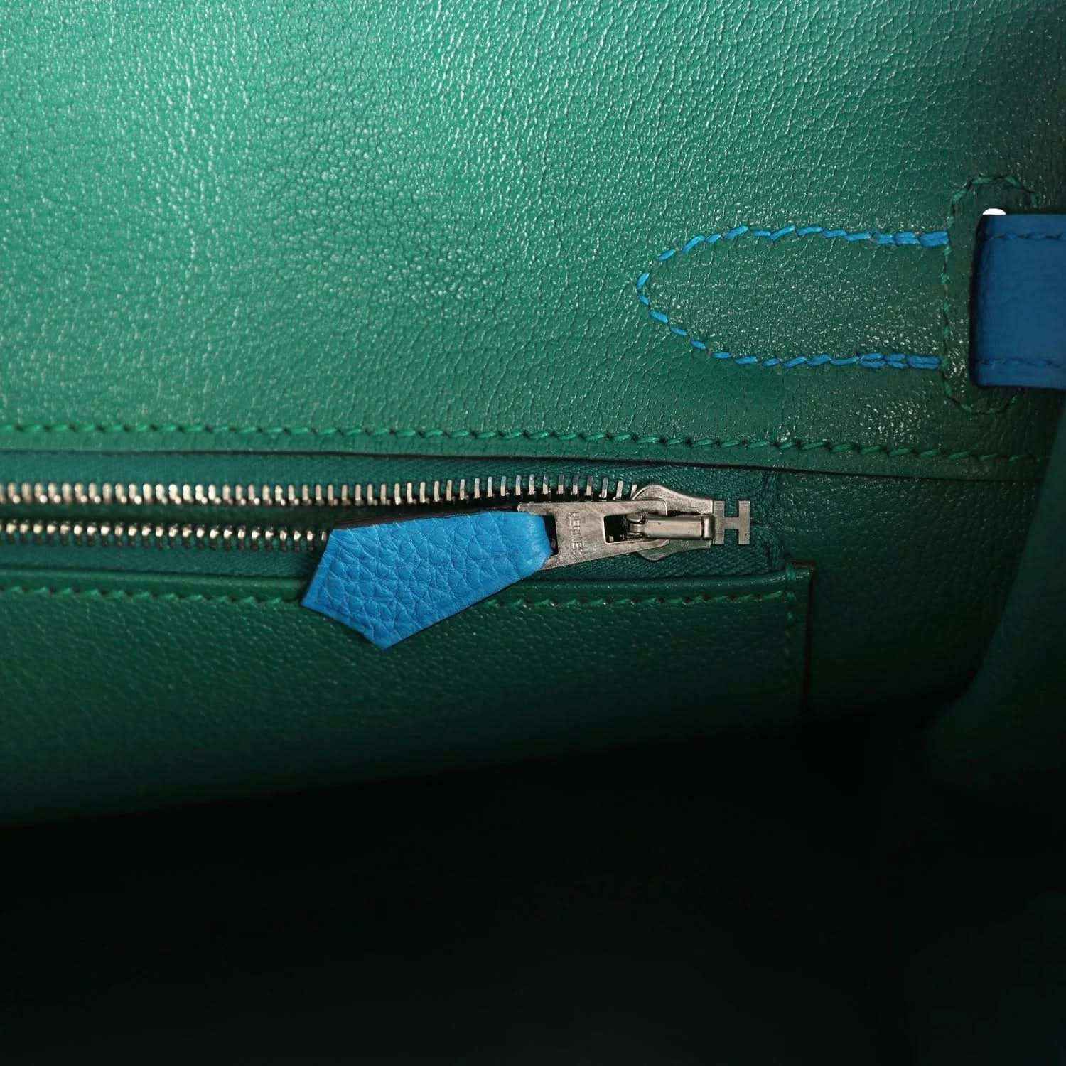 Handbag interior zipper with metal pull and blue leather zipper tab