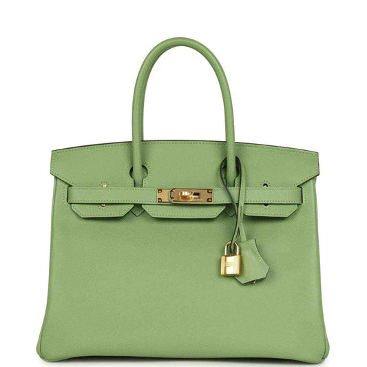 Green leather handbag with top handles, front flap and gold-tone clasp