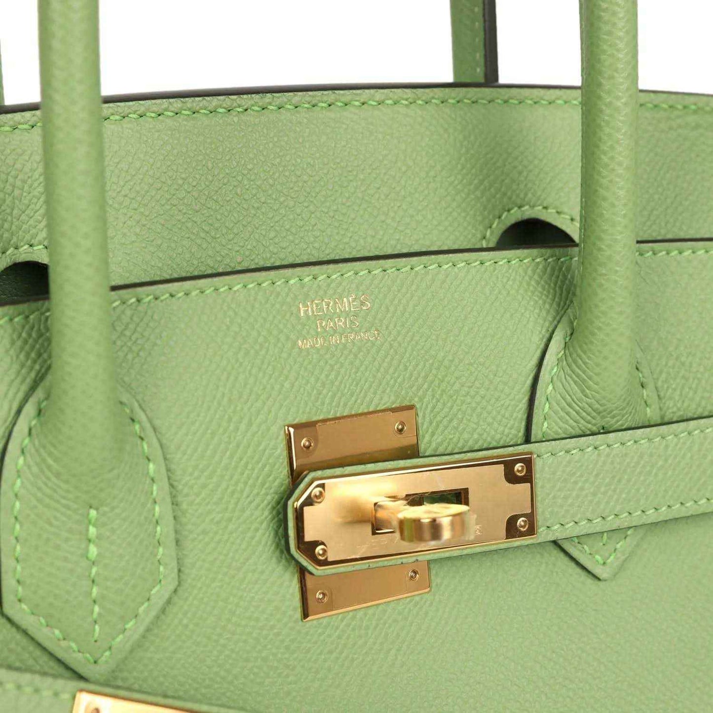 HERMES green leather handbag close-up with gold-tone front clasp hardware and lock