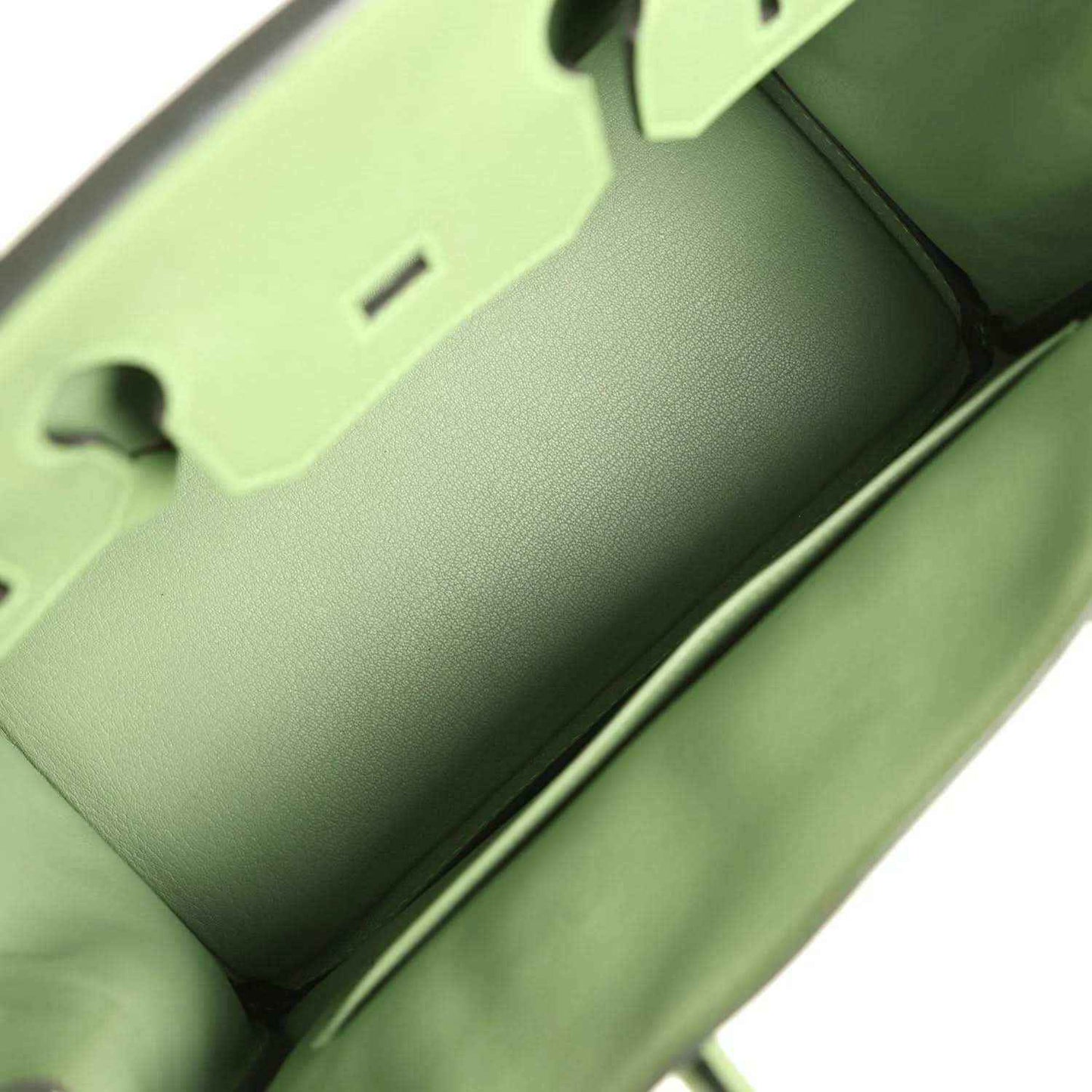 Green leather handbag interior view with smooth lining and edge seam details