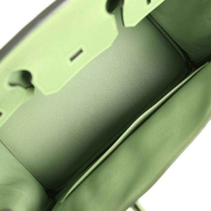 Green leather handbag interior view with smooth lining and edge seam details
