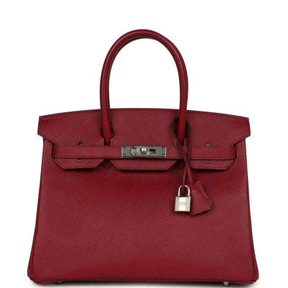 Red leather handbag with two top handles, front flap and silver-tone lock