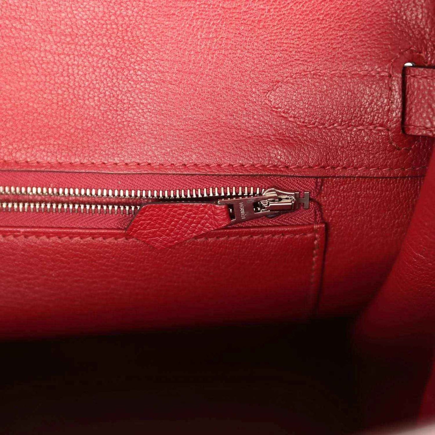 Red leather interior with zipper track and silver-tone zipper pull
