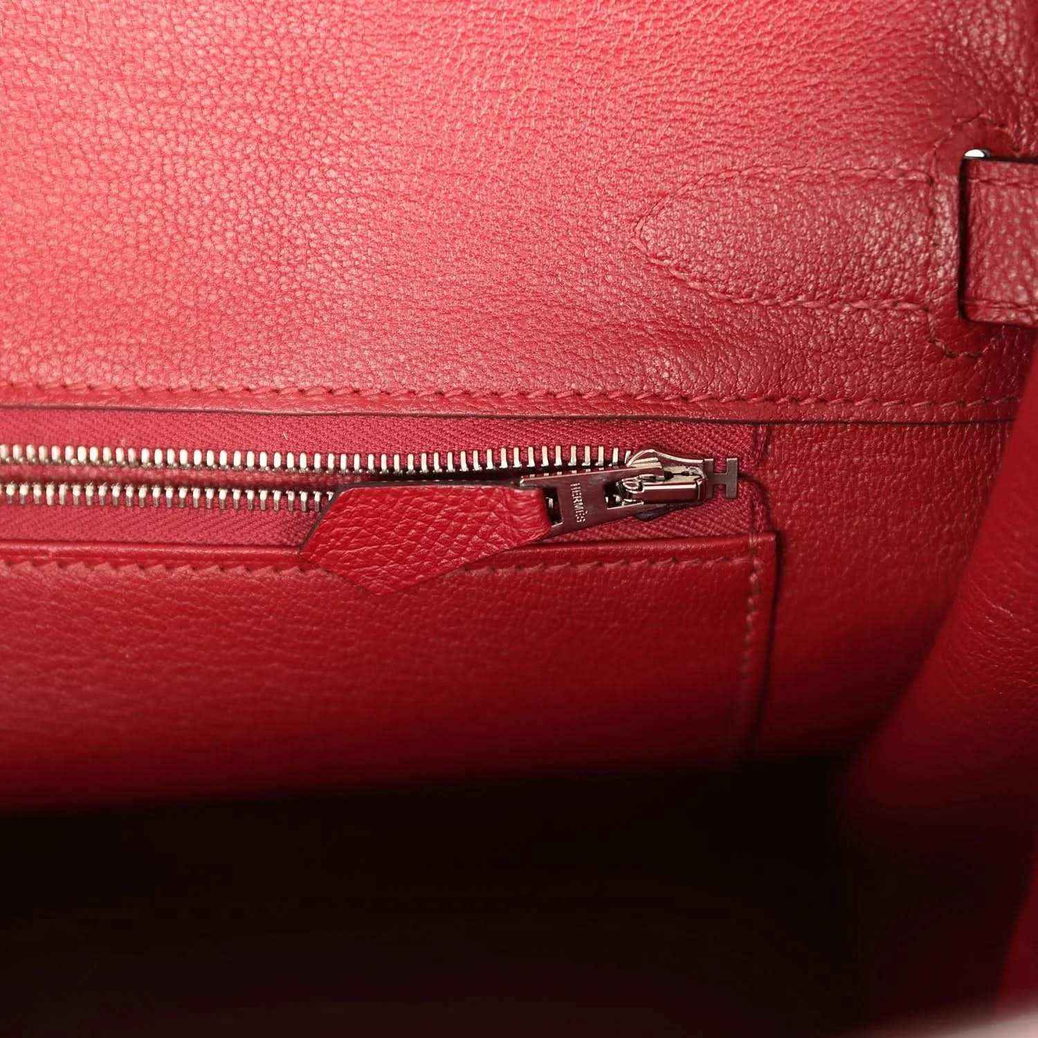Red leather interior with zipper track and silver-tone zipper pull